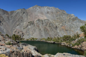 Scenic view of "Par Value" North Ridge Pond 2021-08-19, #18, with Monument Ridge in the distance; lacks fairy shrimp; Bridgeport Ranger District, Humboldt-Toiyabe National Forest, Hoover Wilderness