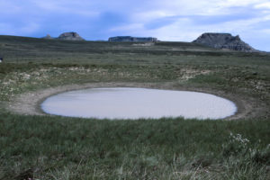 Scenic view of Section Marker Pond 1987-06-22, #2424, with Oregon Buttes in distance; has fairy shrimp; Rock Springs BLM Office