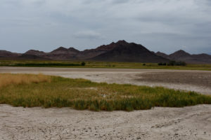 Scenic view of Rawhide Hot Spring Lake 2022-08-05, #01, with Fissure Ridge in distance; dry; Stillwater BLM Office