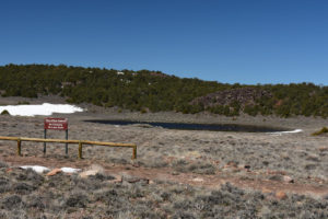 Scenic view of Small Rare Plant Habitat Pond 2019-04-24 #01, with sign, has fairy shrimp; Bridgeport Ranger District, Humboldt-Toiyabe National Forest, Wovoka Wilderness