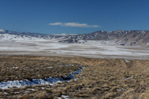 Scenic view of Teels Marsh Playa Lake 2022-02-10, #02, with Sierra Nevada on the horizon; snow; Stillwater BLM Office