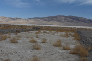 Scenic view of Teels North Well Site Pond 2021-04-07, #02, with unnamed hills in distance; dry; Stillwater BLM Office