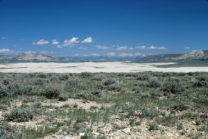 Scenic view of Killpecker Dunes 1987-06-19, #2313, with Essex Mountain, Steamboat Rim, and Wind River Mountains; Rock Springs BLM Office