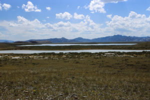 Scenic view of Little "Piaya Lake" and "Piaya Lake" 1989-06-08, #0326, with Independence Rock in distance; has fairy shrimp; private land