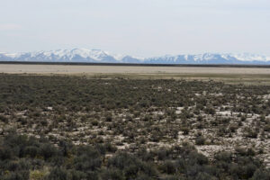 Scenic view of Twelvemile Flat Playa Lake 2023-04-27, #17, with Bull Run Mountains in distance; dry; Tuscarora BLM Office