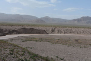 Scenic view of Windy Gravel Pit Pond 2023-09-01, #06, with Monte Cristo Range in background; has fairy shrimp; Tonopah BLM Office