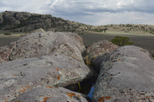 Scenic view of Hill 7122 Rock Pool 2025-08-17, #9, with Tin Cup Mountain in background; dry; Lander BLM Office